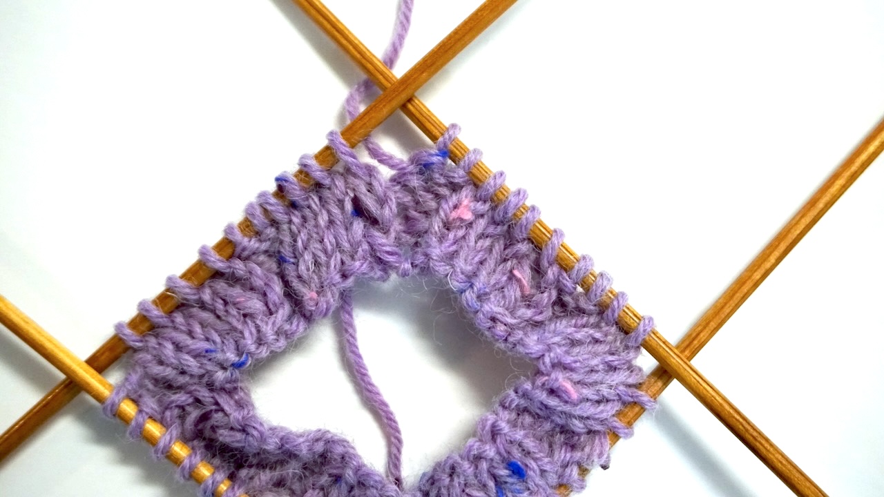 Step-by-step knitting photo showing cable knit initial setup on double pointed needles