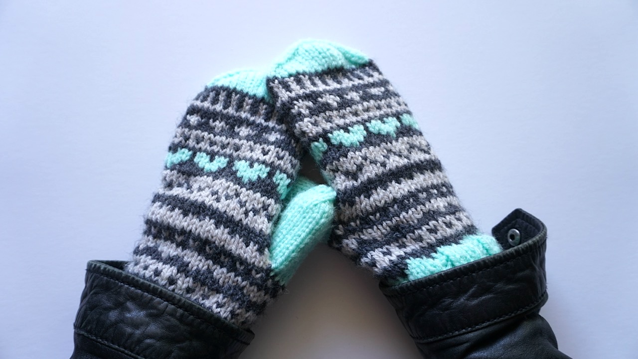 Knitted mittens featuring Fair Isle knitting pattern in pastel mint, light gray and dark gray yarn