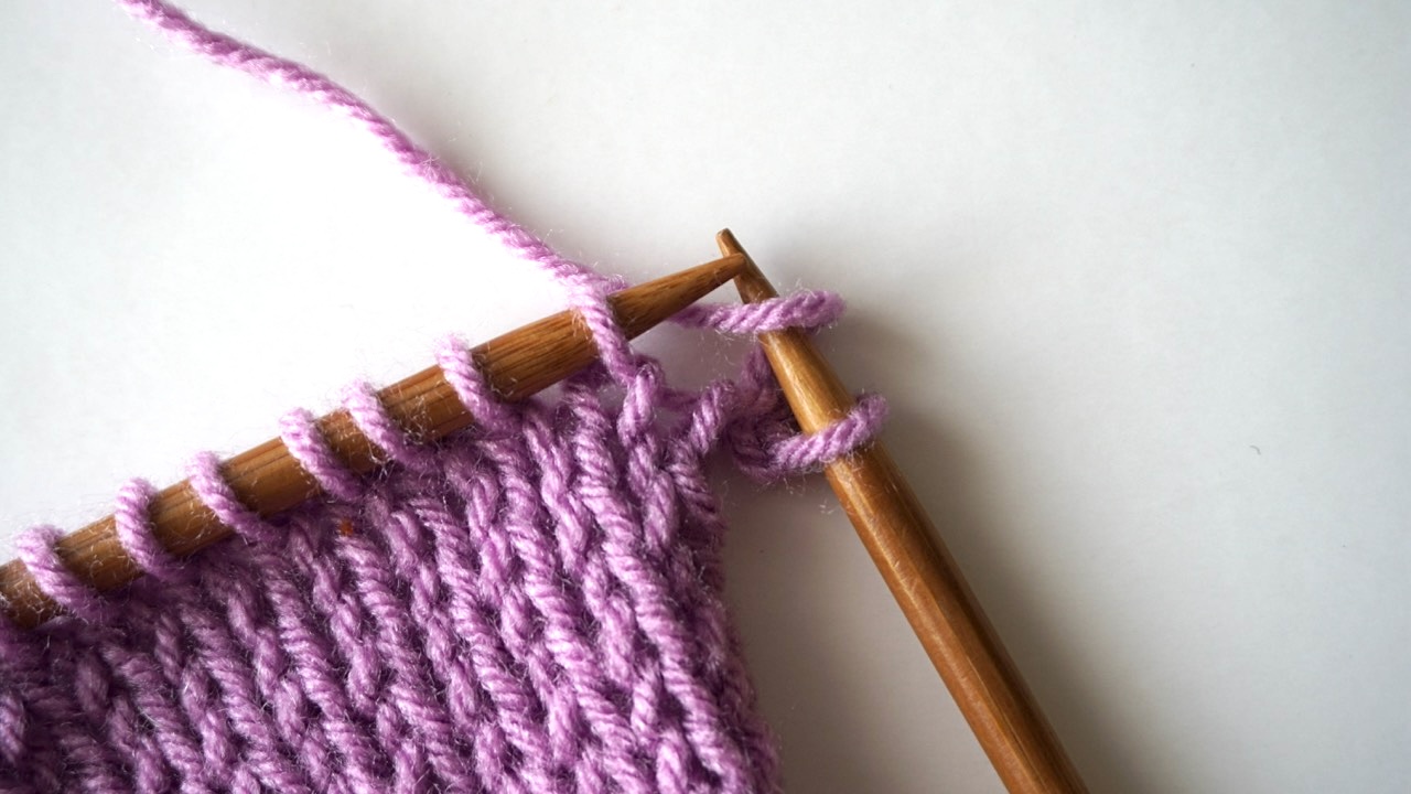Wrapping the yarn over the right needle in an unfinished knitting project