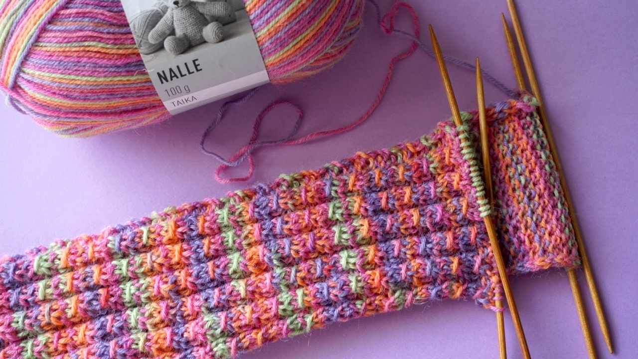 Mock cable stitch pattern being worked on double pointed needles