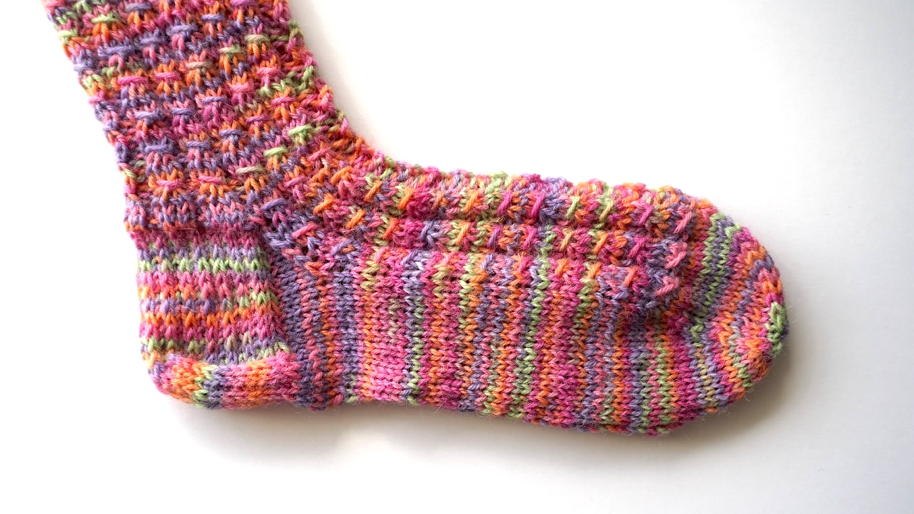 Mock cable sock featuring textured pattern in colorful yarn