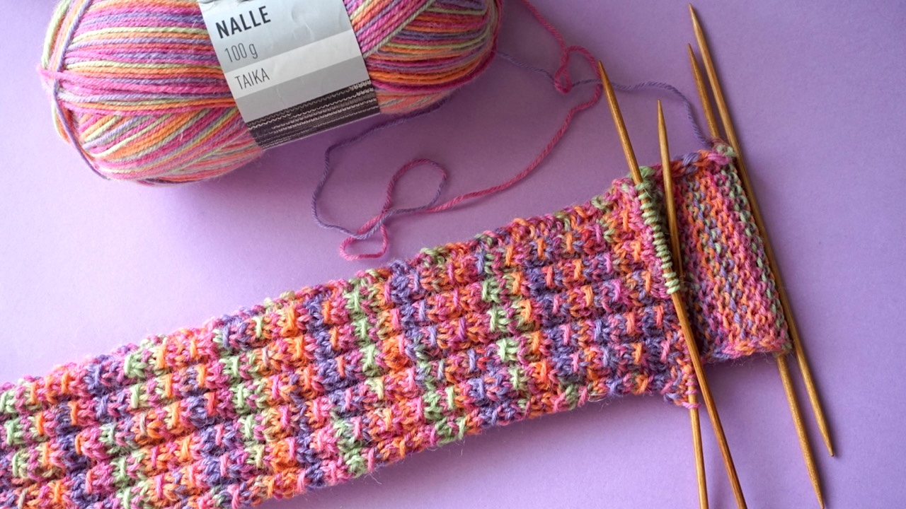 Mock cable sock pattern being worked on double pointed needles